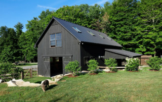 Grey barn tucked in hillside